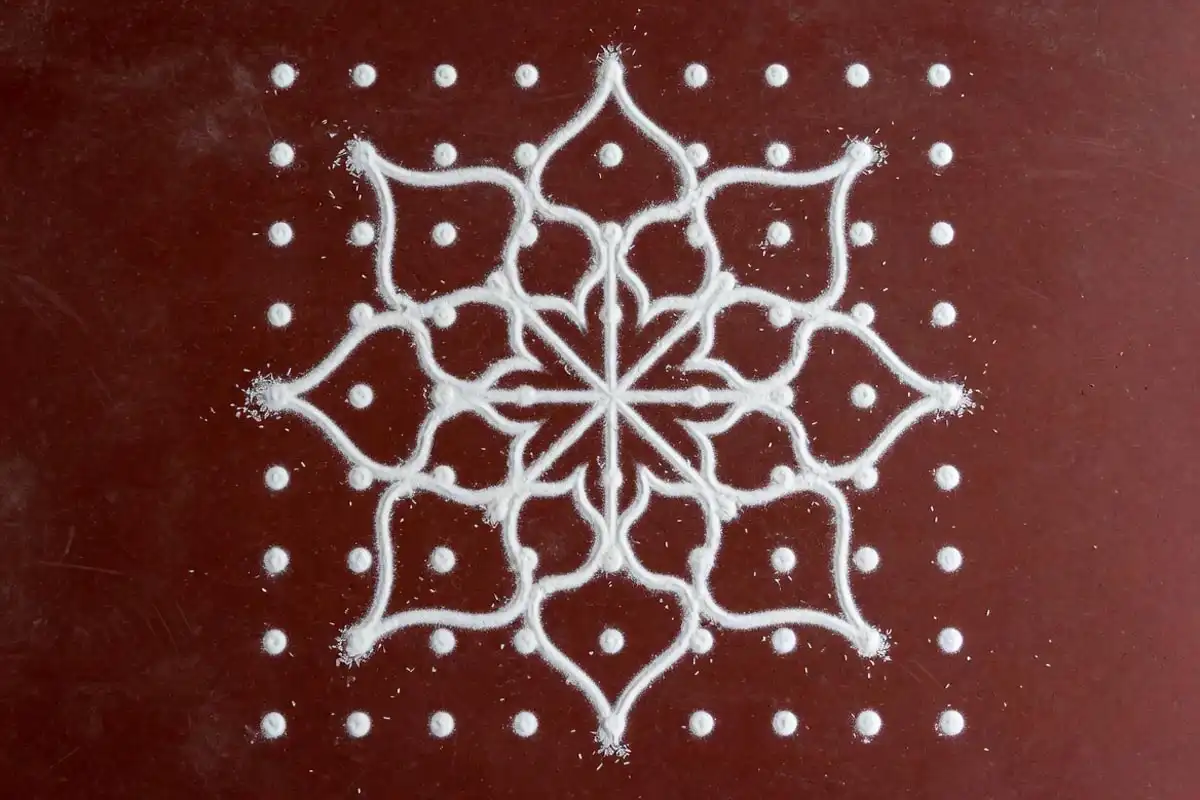 Nine by nine dot grid rangoli forming an eight-point star