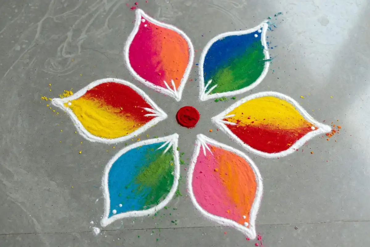 Curved petal burst freehand rangoli with six teardrop petals
