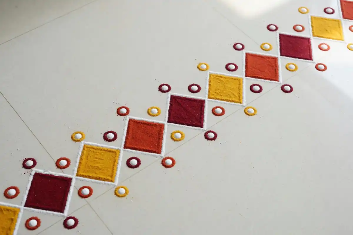 Geometric border strip rangoli with diamonds and dots