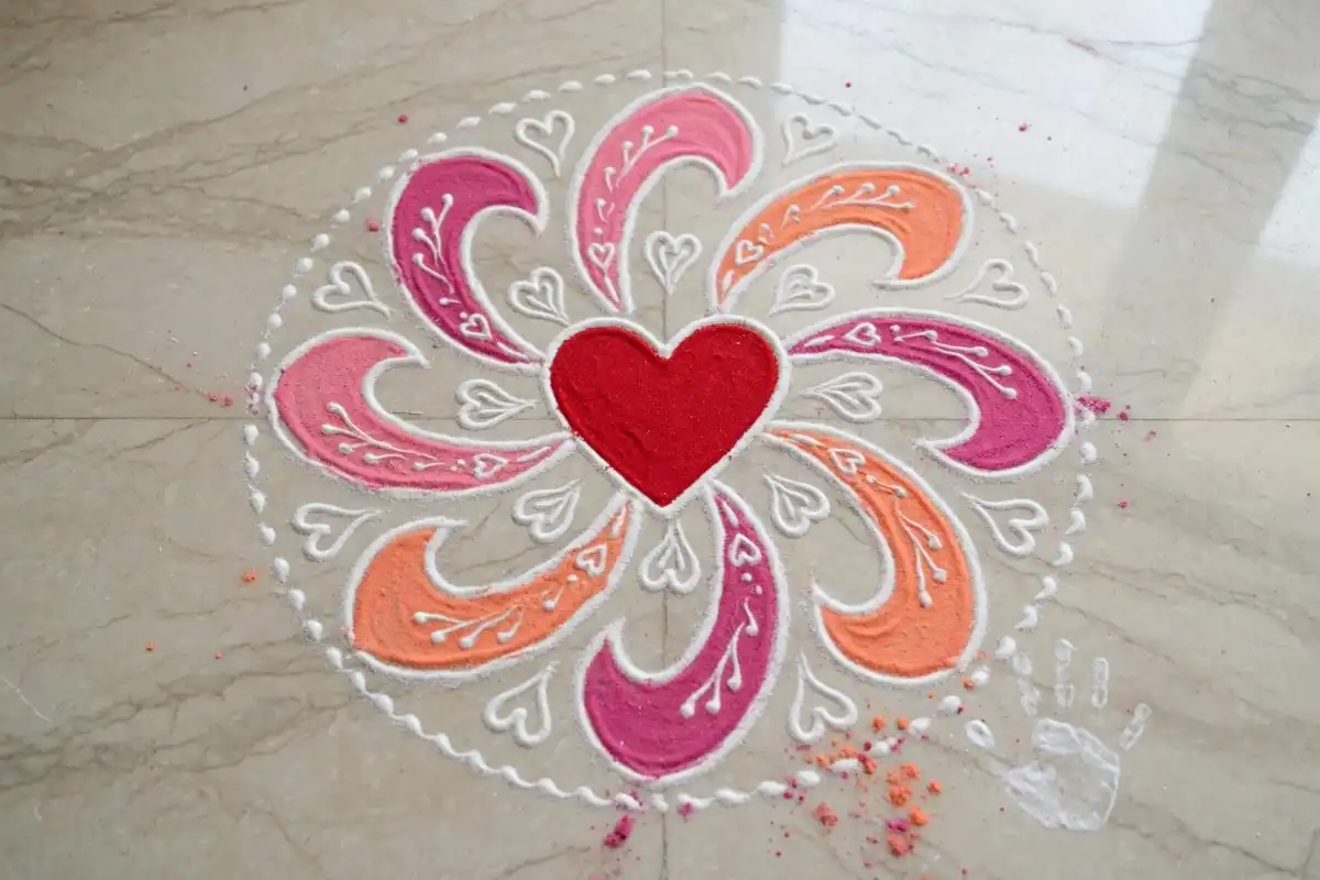 Heart center rangoli with petal lines around it