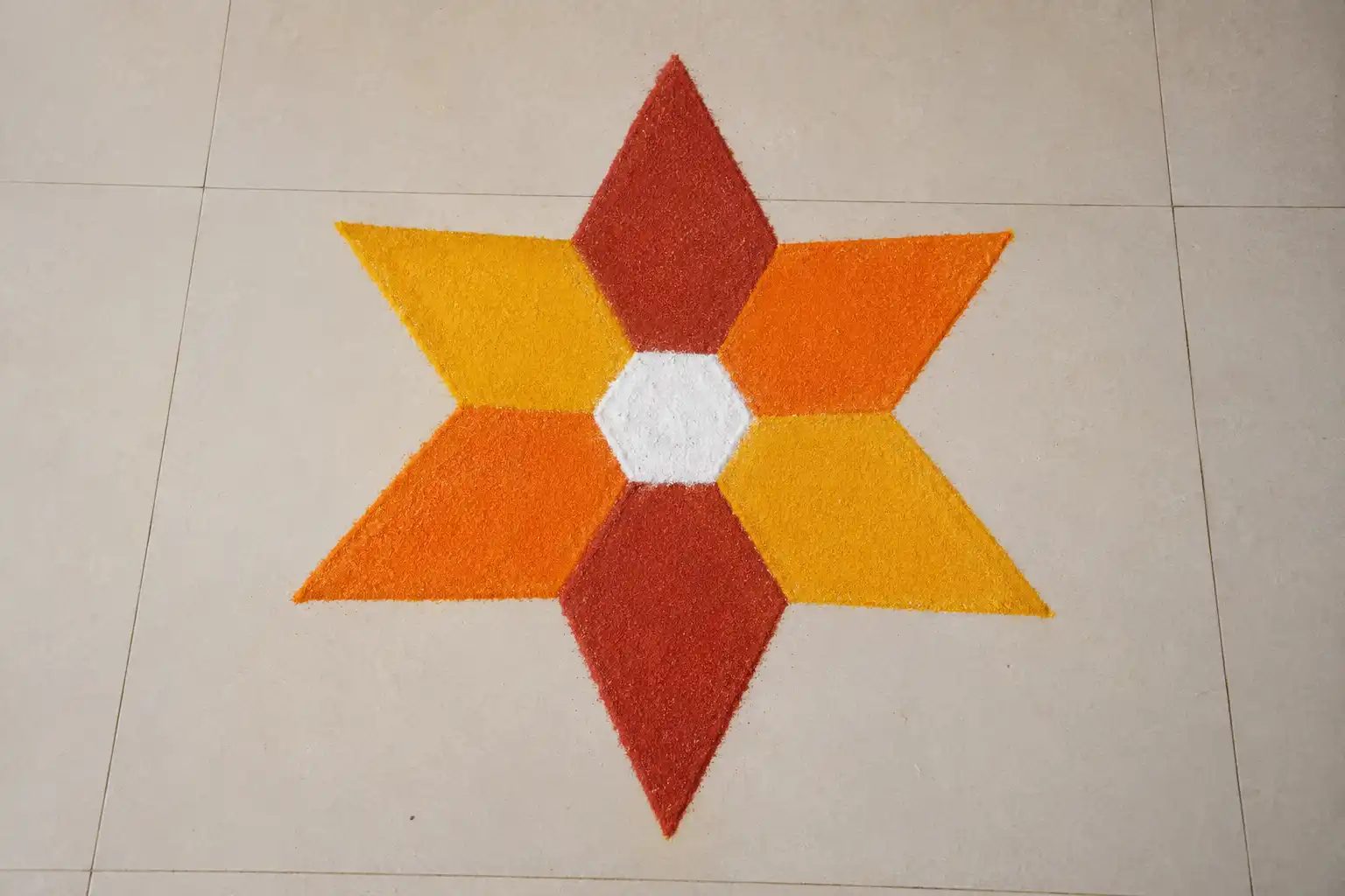 Hexagon burst rangoli with six pointed petals