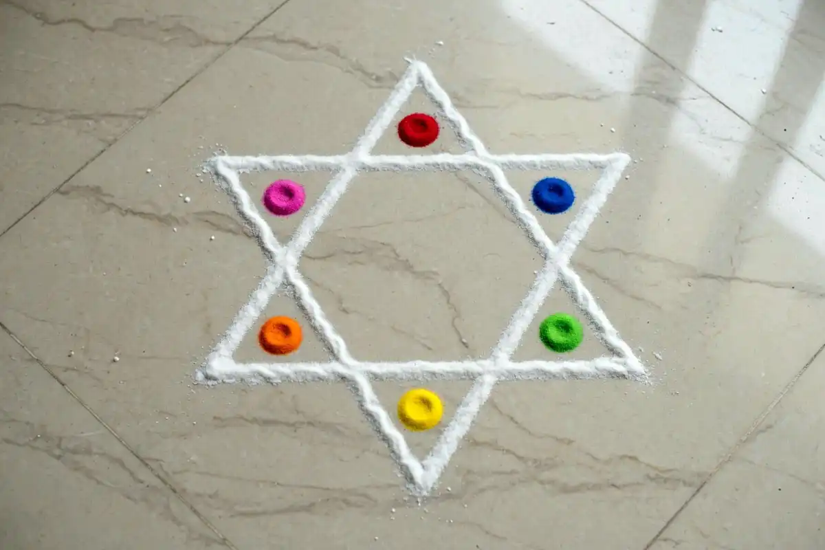 Six point star rangoli with colored dots in each point