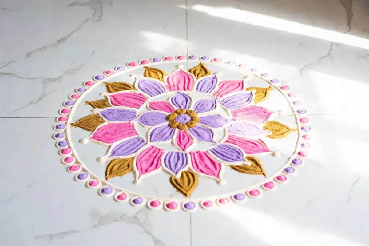 Aesthetic rangoli ideas with pastel floral motif on white marble floor