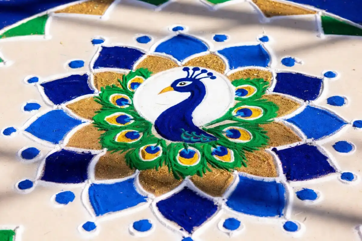 Beautiful rangoli design featuring a peacock motif with colorful feathers