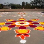 A large and colorful big rangoli design made on a floor for a festival