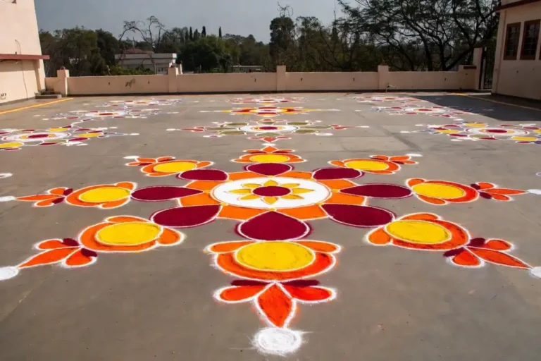 A large and colorful big rangoli design made on a floor for a festival