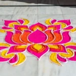 Colorful rangoli border design with floral patterns on floor