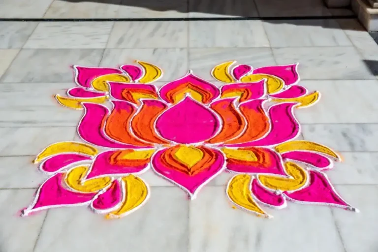 Colorful rangoli border design with floral patterns on floor