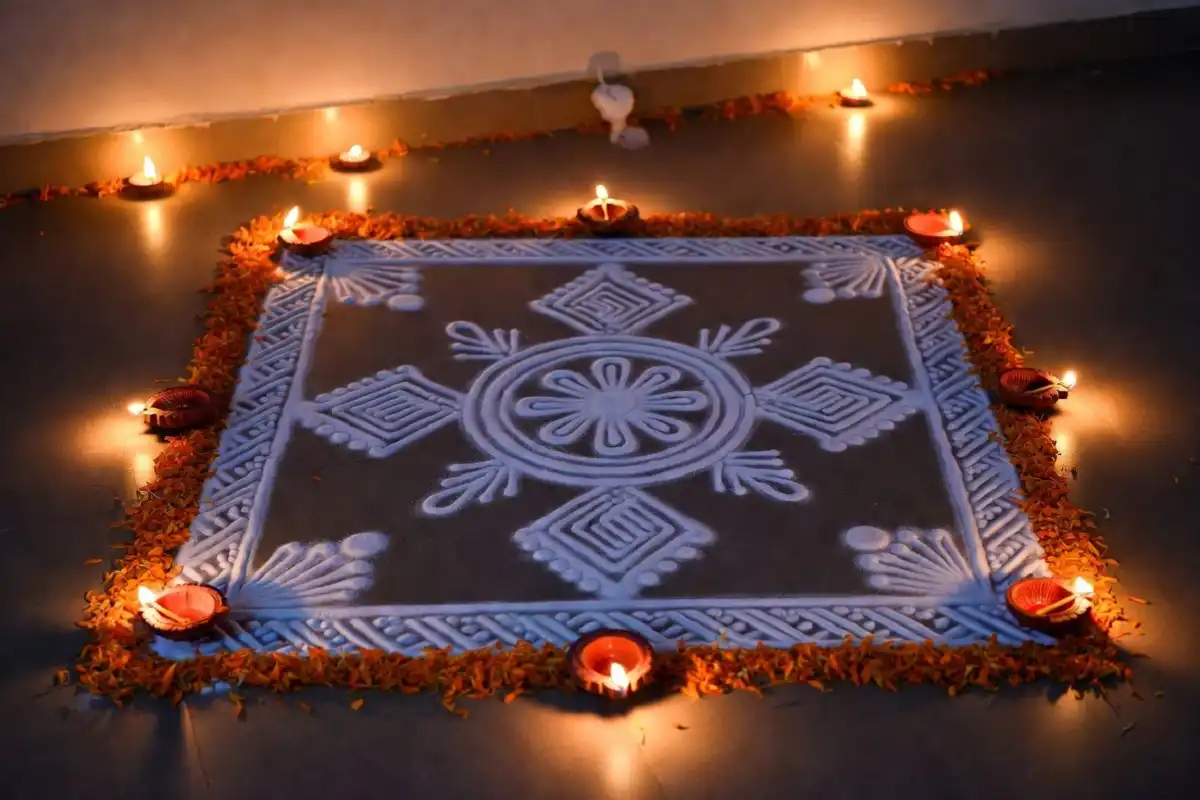 Diwali rangoli border design decorated with diyas and marigold flowers