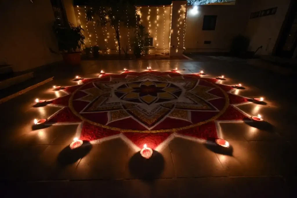 Diwali rangoli design with diya border glowing at night during the festival