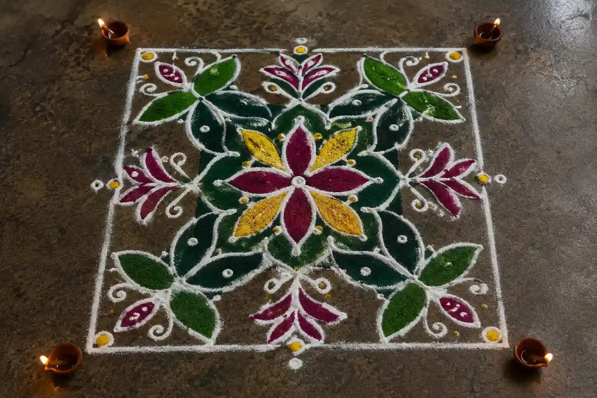 Dotted grid square rangoli design with colorful floral, leaf, and star patterns