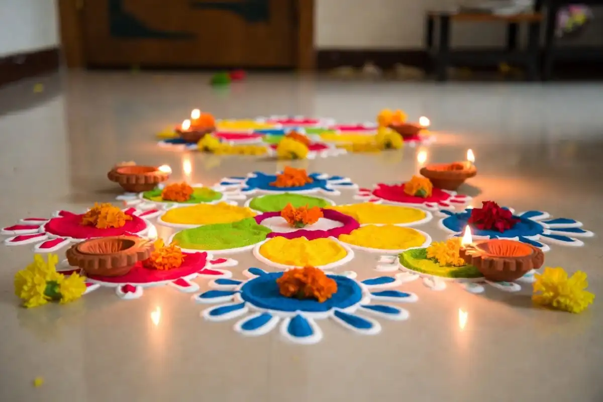 Finished rangoli design easy Diwali style with diyas and marigold flowers on a festive home floor