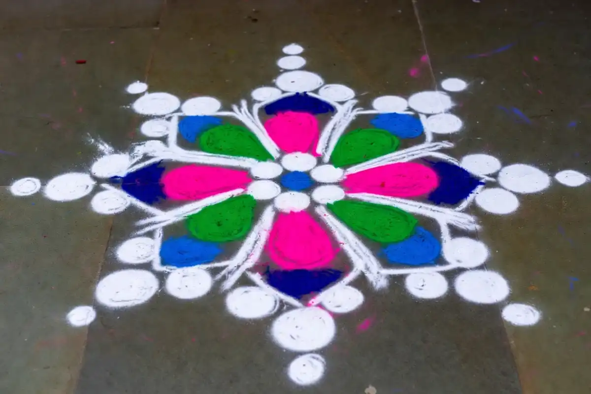 Easy dot-based floral rangoli design for Diwali using chalk and colored powder