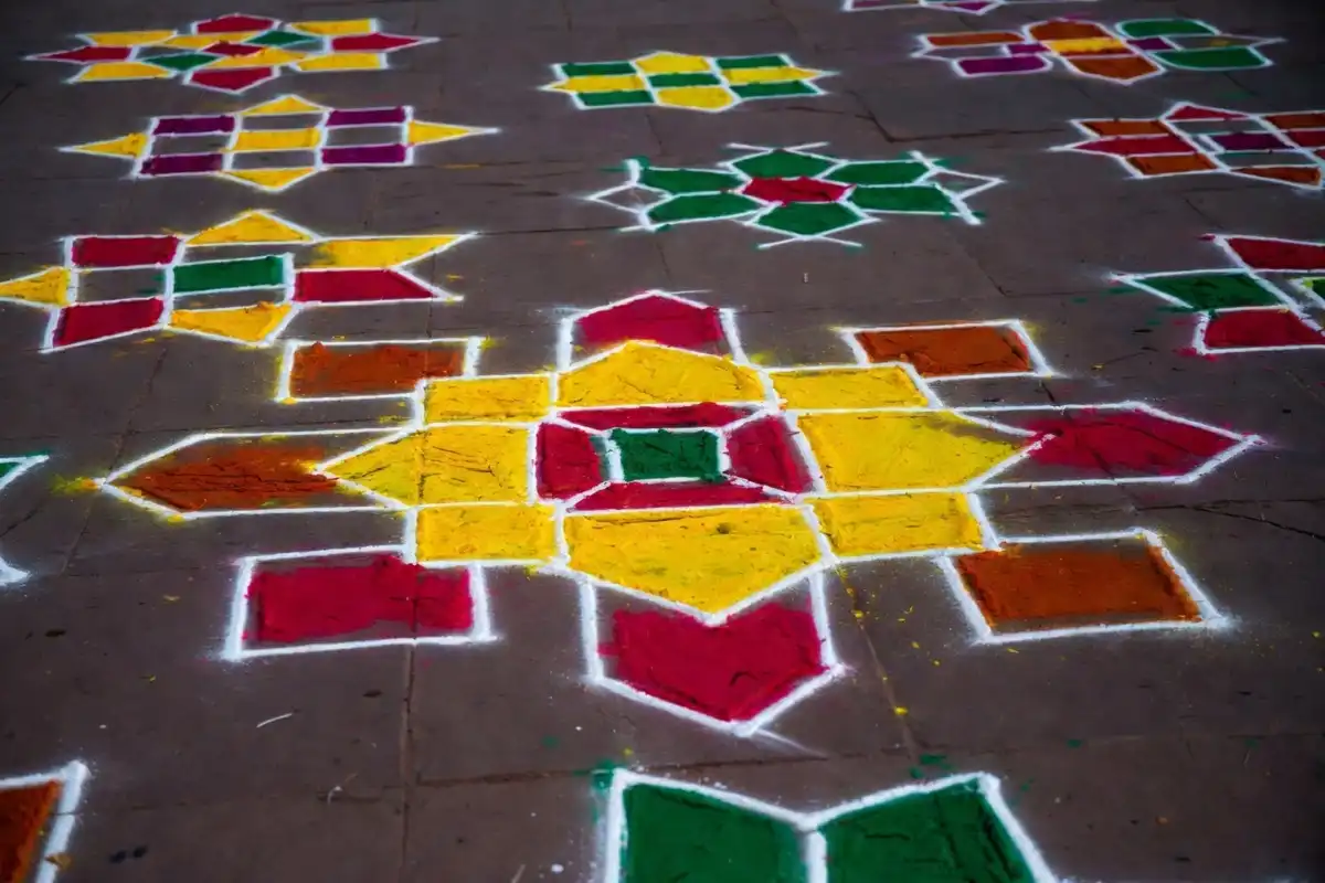 Collection of rangoli design easy geometric patterns using colorful powders on a dark floor