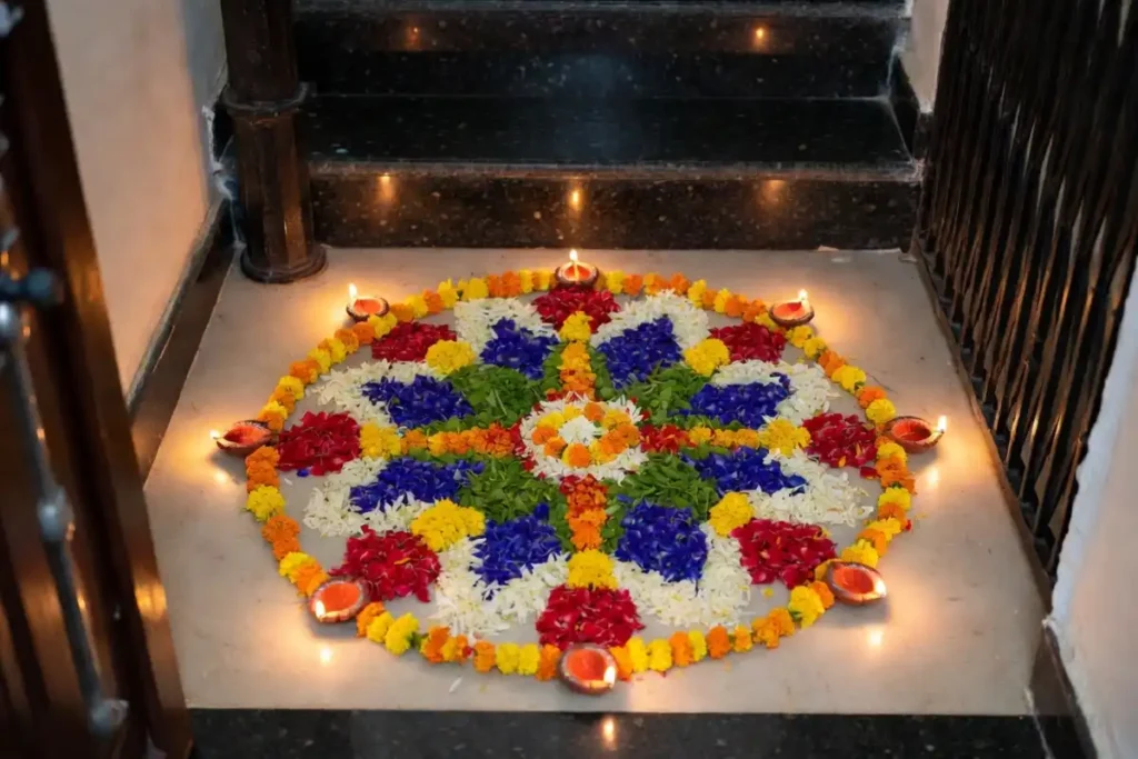 Festive Diwali simple rangoli at an apartment entrance with flower petals and clay diyas