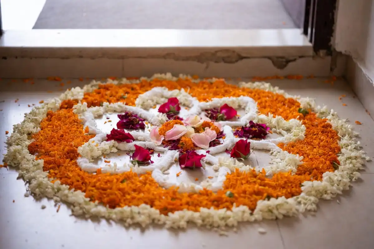 Floral circle rangoli design with marigolds and rose petals