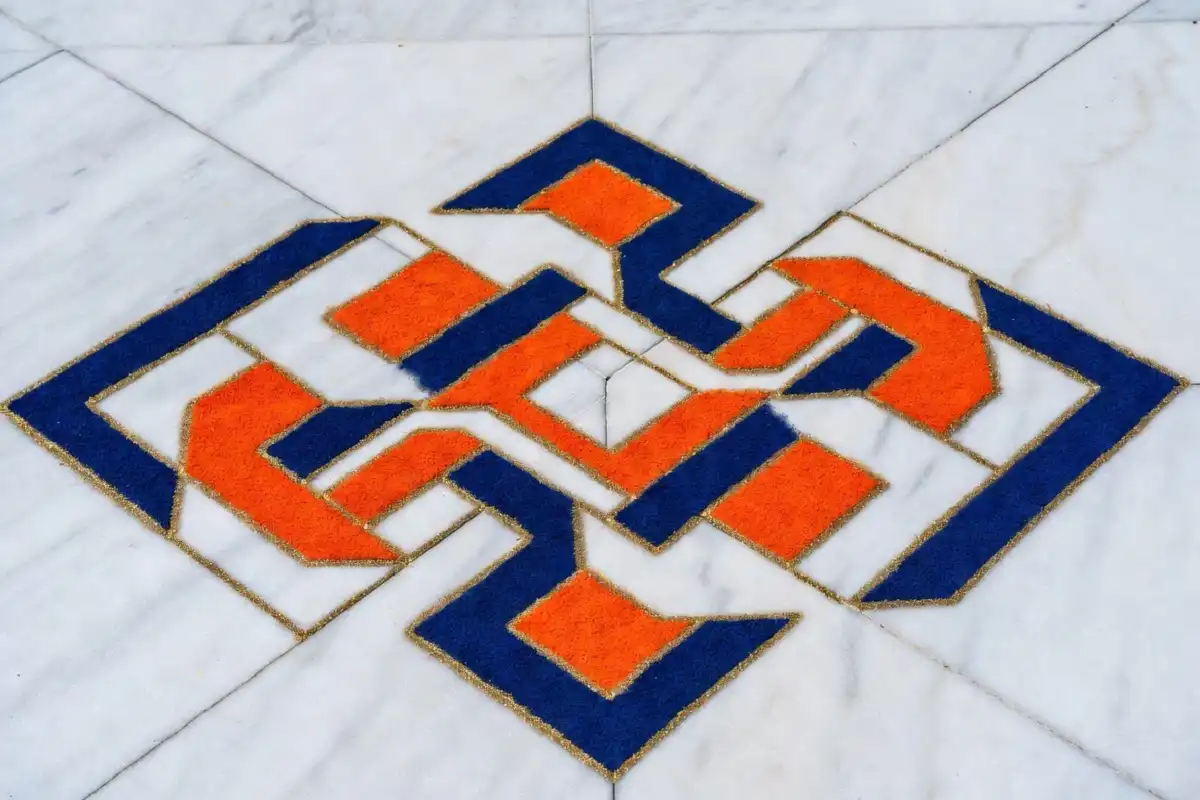 Geometric border rangoli design with diamond and zigzag patterns in bright colors