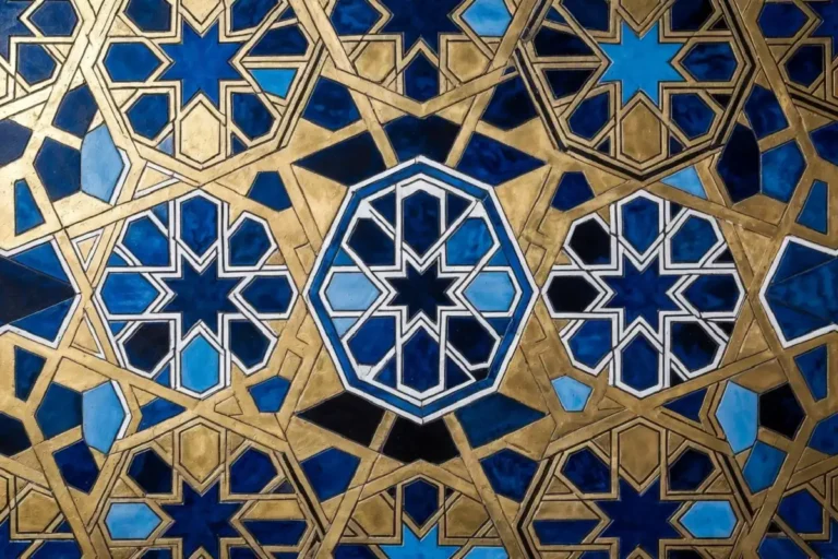 Intricate geometric design with interlocking hexagons and star polygons in blue and gold