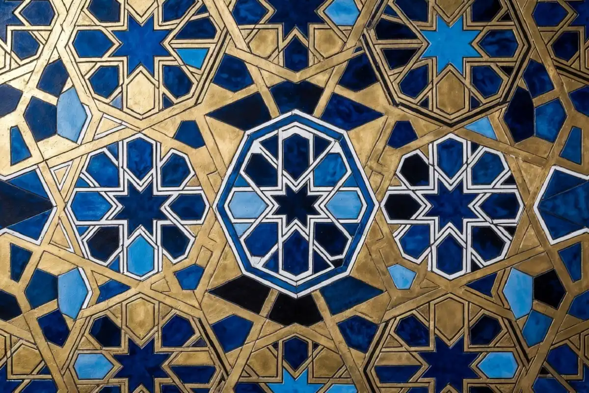 Intricate geometric design with interlocking hexagons and star polygons in blue and gold
