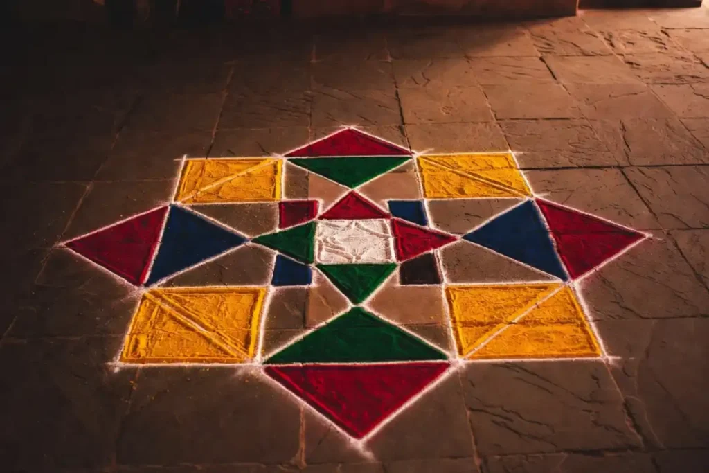 Colorful traditional Indian rangoli floor art floor pattern with central star and diamond grid