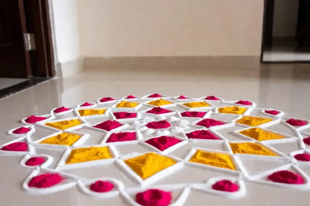 Geometric dot rangoli design in white, yellow, and red at an apartment entrance