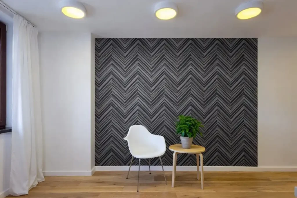 Modern room interior featuring black and white geometric pattern wallpaper