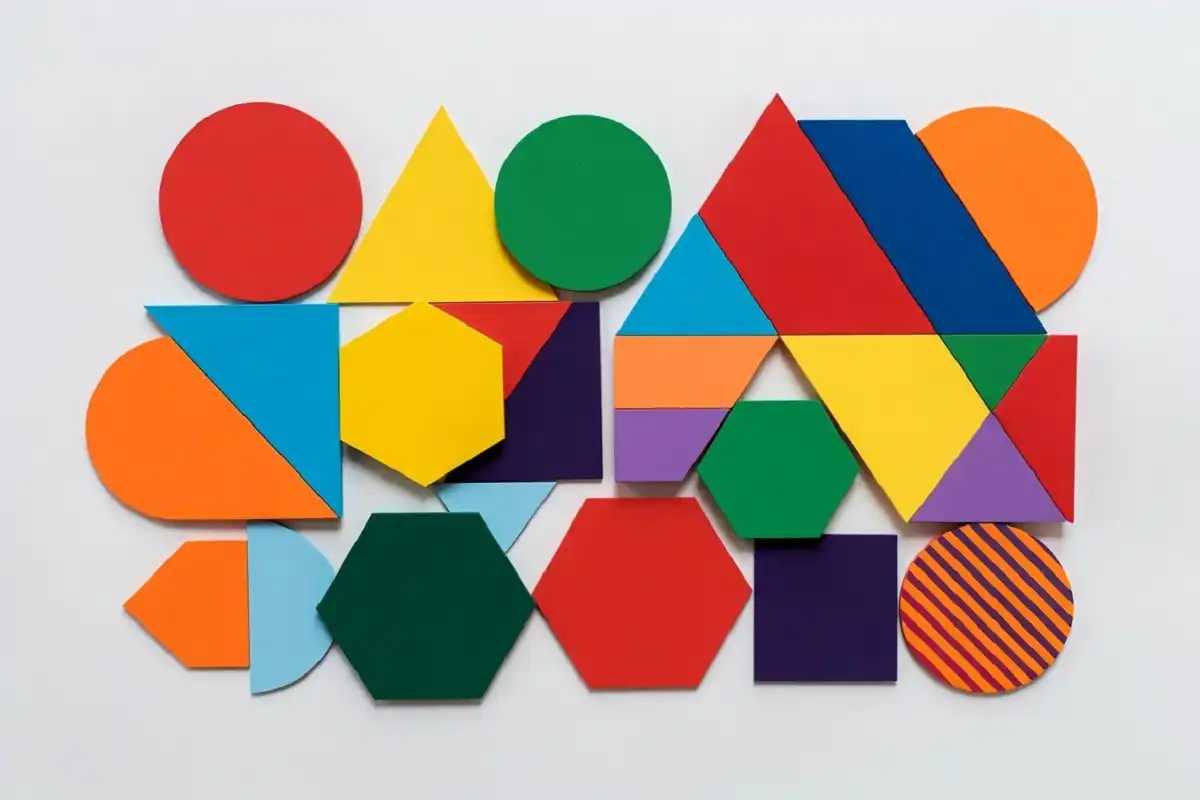 Colorful geometric shapes arranged in a symmetrical flat-lay pattern design