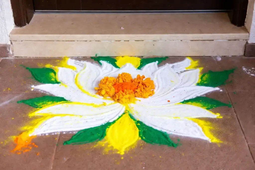 Traditional ornamental floral motif design on a doorstep using colored powder