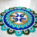 Colorful peacock circle rangoli design made with vibrant powder colors on floor