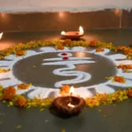 Traditional rangoli design for Dhanteras featuring Lakshmi footsteps with marigold petals and diyas