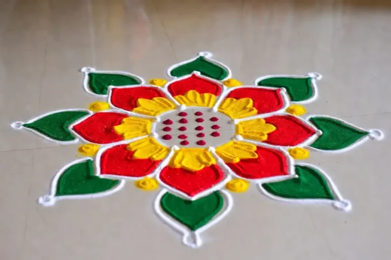 Colorful rangoli easy design with floral pattern drawn on floor using colored powder