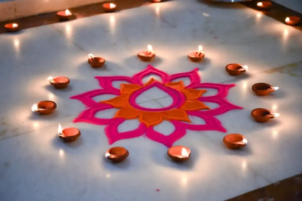 Lotus flower rangoli easy design with pink petals and clay diyas on marble floor
