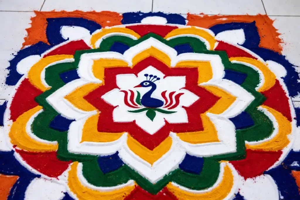 Lotus and peacock motifs in a detailed rangoli ki design on a floor