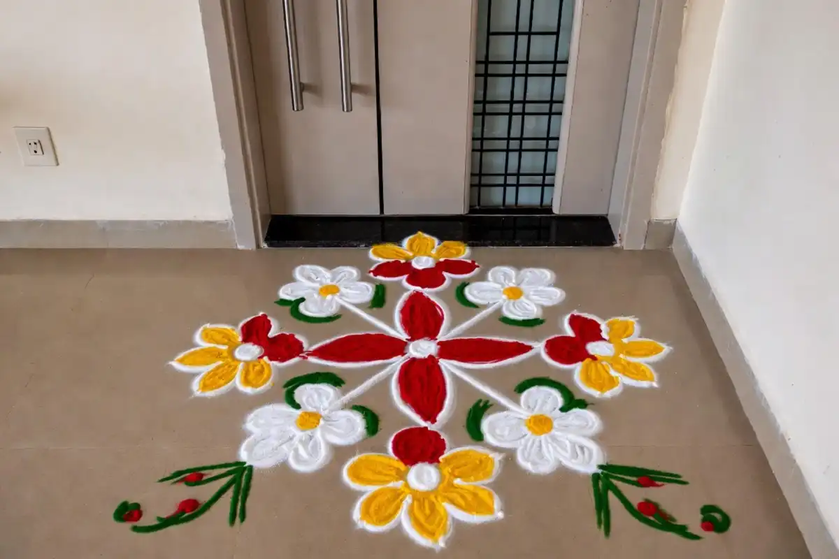 Simple rangoli for apartment entrance with colorful floral and geometric patterns