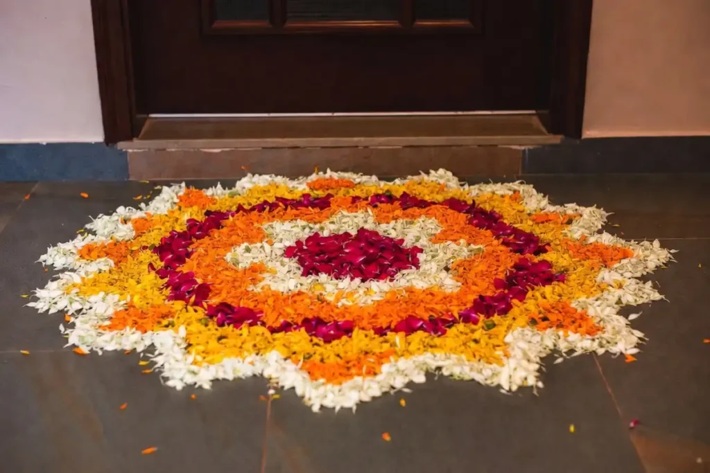 Compact floral petal rangoli at a doorstep suited for small spaces