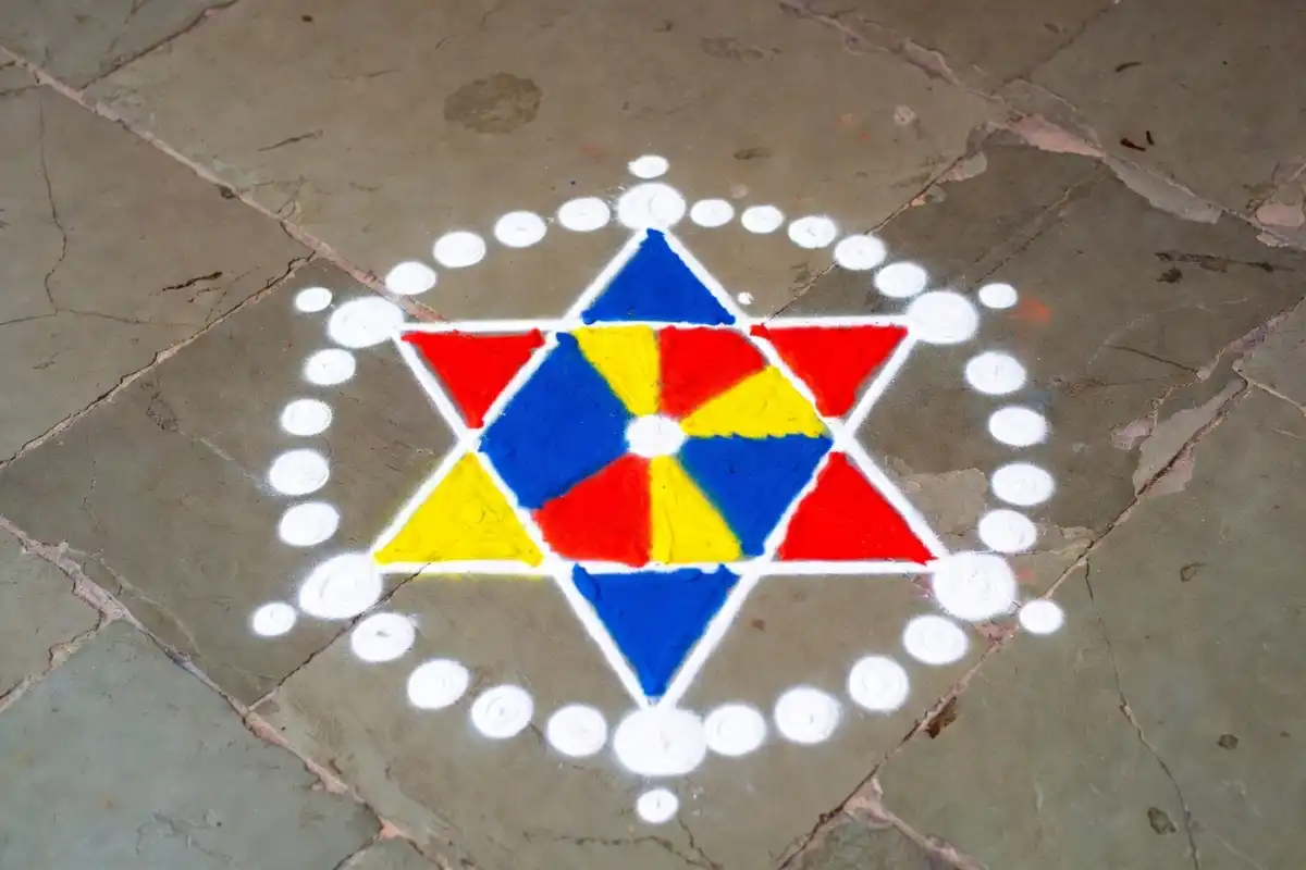 Colorful small rangoli design for New Year with geometric star pattern