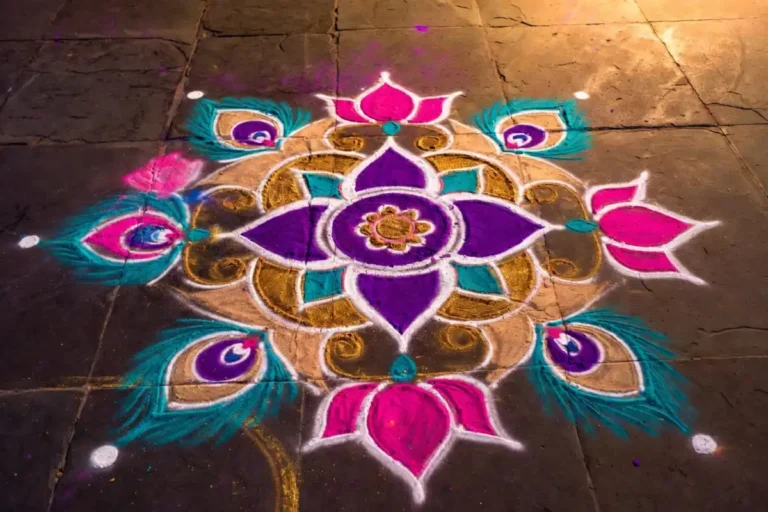 A stunning unique rangoli design with layered floral patterns and vibrant mixed colors on a dark stone floor