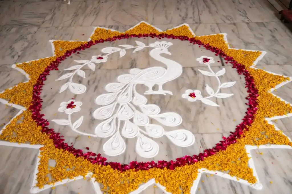 White rangoli design bordered with colorful flower petals for a festival occasion