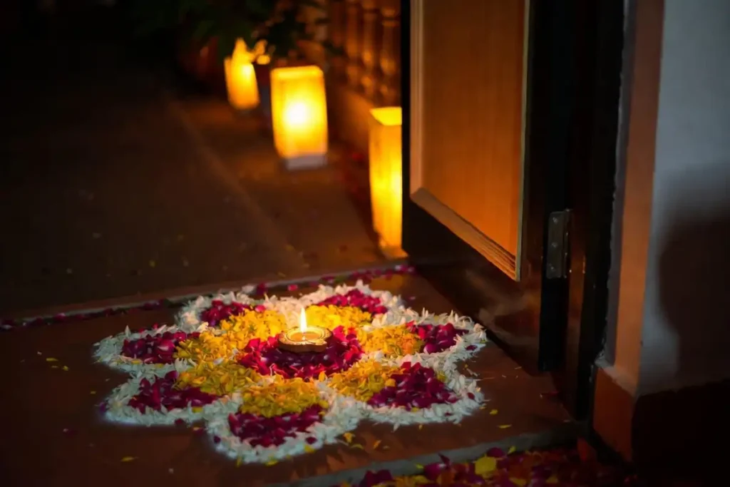 Fresh flower simple petal rangoli at a festive doorway