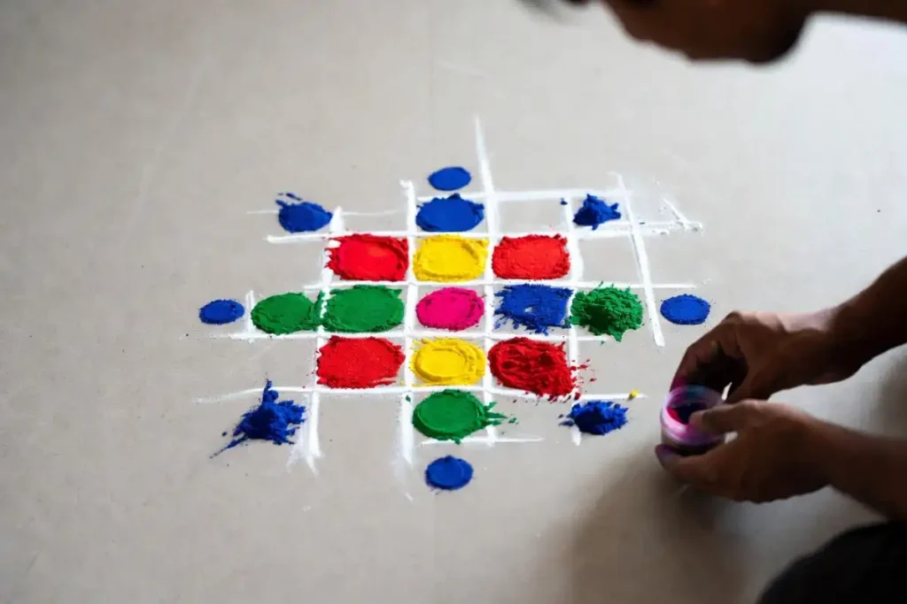 Beginner making a simple dot and flower rangoli pattern by hand