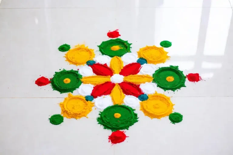 Colorful beginner friendly rangoli art design on white floor with flower and dot pattern