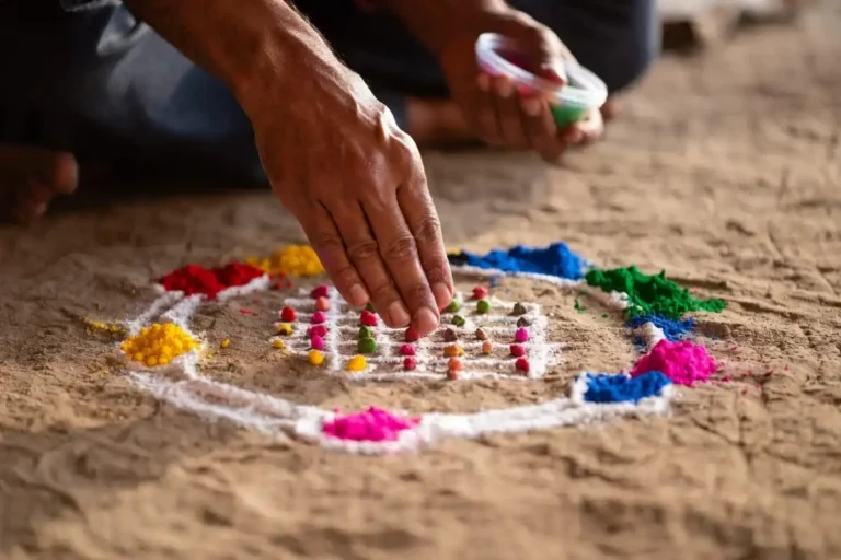 Hands creating a beginner mandala rangoli using a dot grid