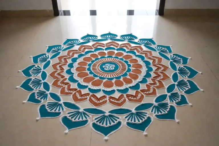 Colorful beginner mandala rangoli with symmetrical circular layers on a doorway floor