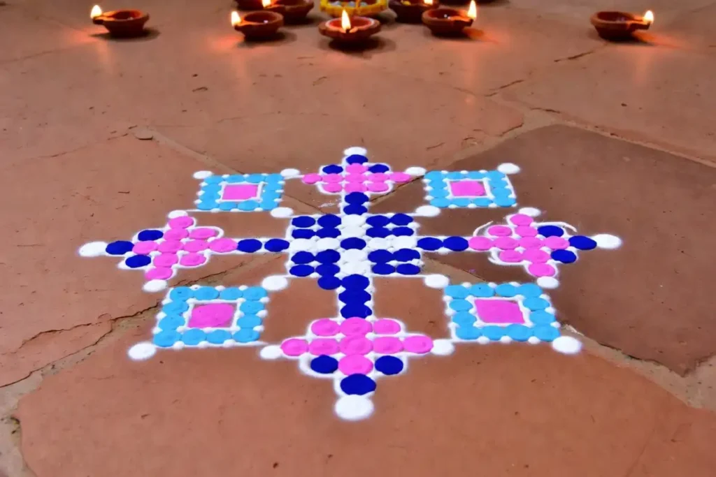 Small dot grid rangoli without stencil easy in pink and blue on terracotta floor