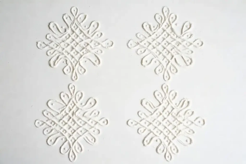 Four easy daily kolam design patterns drawn with white powder on a flat surface