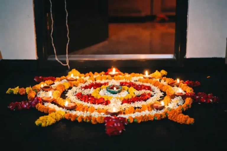 Easy Diwali rangoli at home with flowers and lamps at a doorway