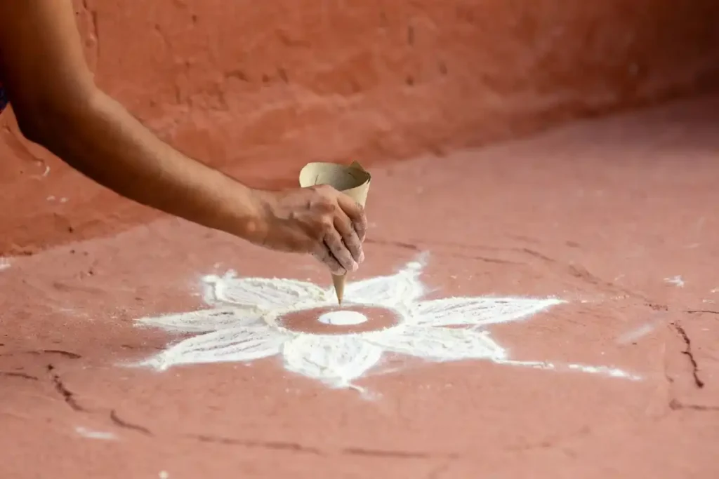 Beginner creating easy festive floor art using dot method on terracotta floor