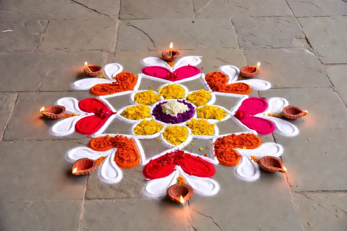 Easy festive floor art with colorful floral rangoli and diyas on a home entrance floor