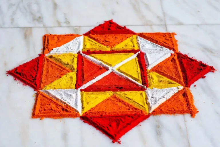 Easy geometric rangoli design with colorful triangles and diamond patterns on a white floor