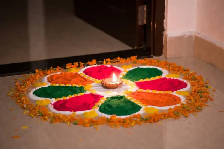 Quick Navratri rangoli with a lit diya and marigold petals at a home entrance